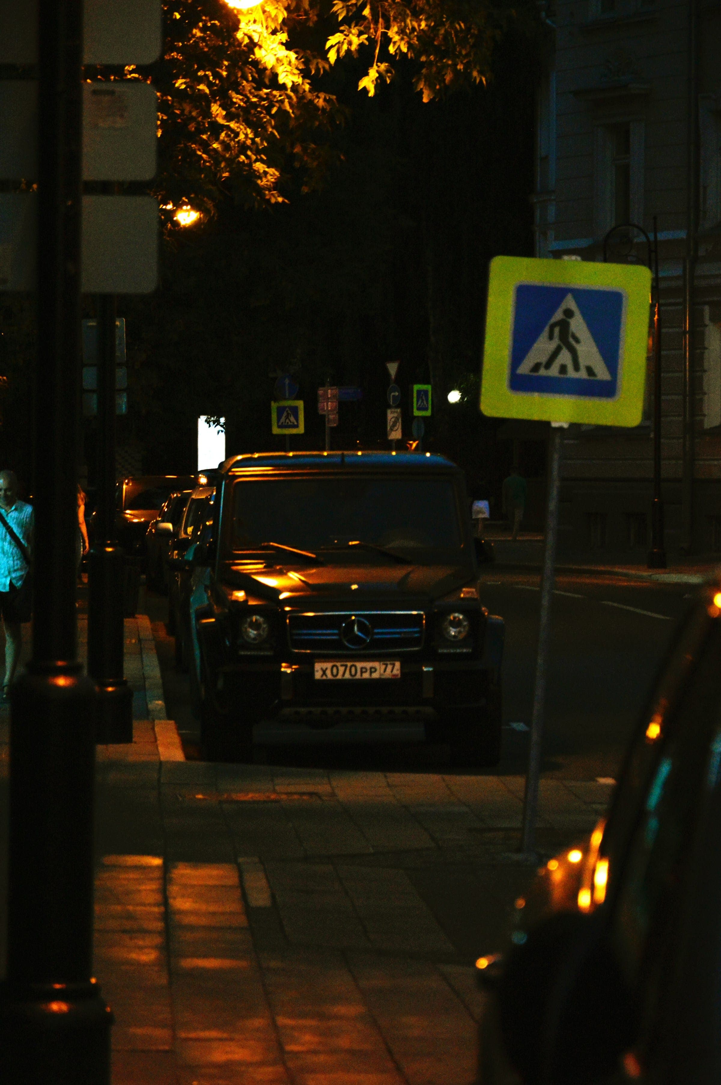 Black SUV parked on a city street at night