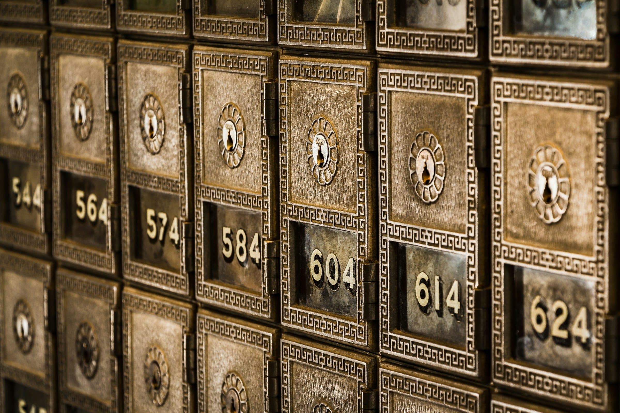 Numbered brass safe deposit boxes in a vault